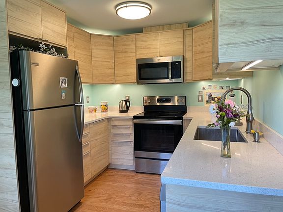 Newer kitchen with quartz counters, nice lighting. (Picture is of almost identical kitchen in another unit).