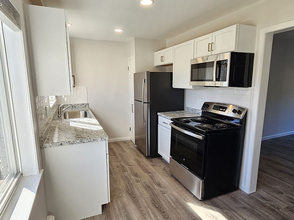 Newly remodeled kitchen features stainless steel GE appliances.