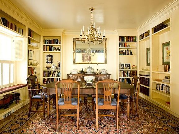 The Dining Room Has Three Walls of Custom Bookcases