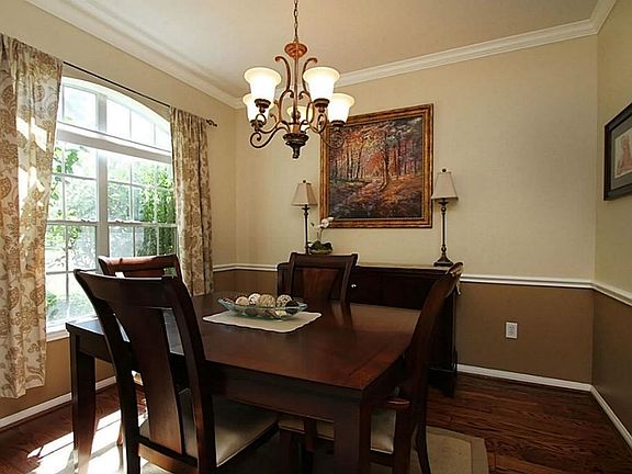 The formal dining room has a chandelier plus crown and chair-rail molding. This is a wonderful place