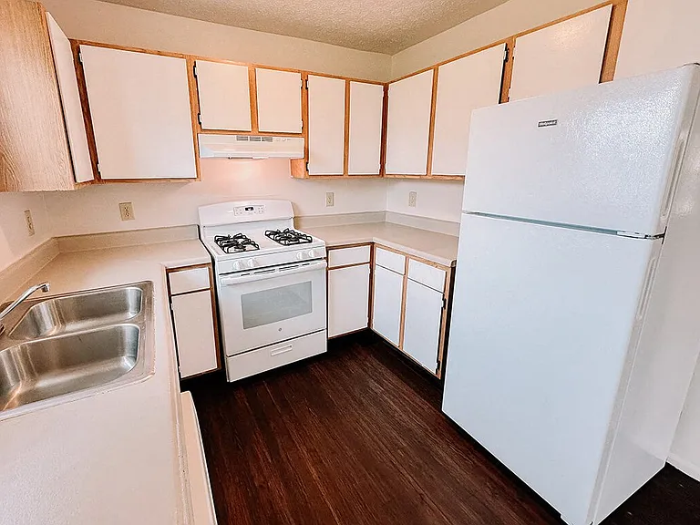 Large Kitchen with White Cabinets and Appliances