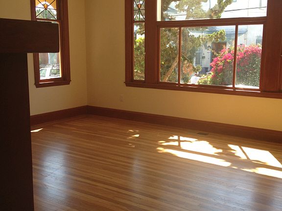 Big living room with hardwood floors and original windows