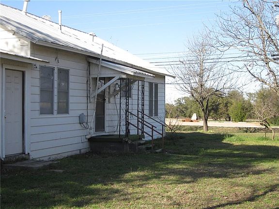 The side of the house has another entrance which leads to the kitchen, and a door that leads to the garage