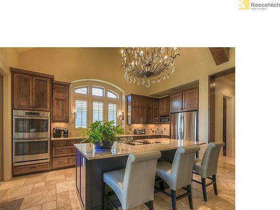 Elegant chandelier, granite counters, huge island and double ovens make entertaining a pleasure.