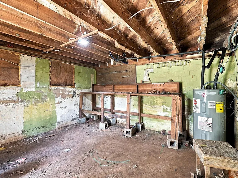 Cellar space providing room for workshop, storage and below ground safety shelter.