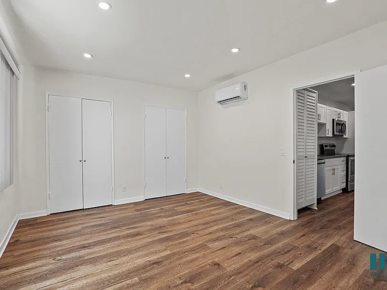 Bedroom with Multiple Closets, Vinyl Flooring, and Recessed Lighting