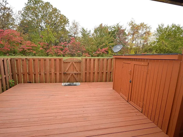 Wooden patio with a shed for storage