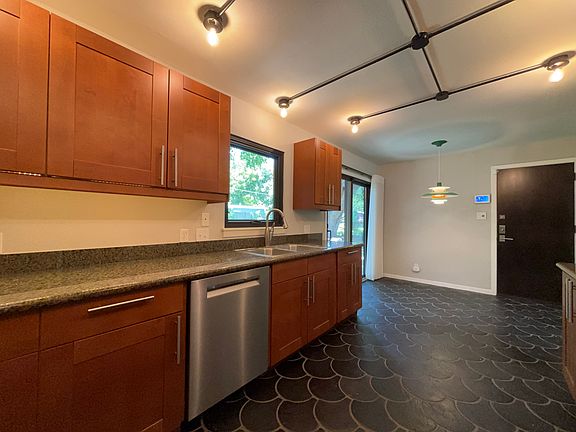 Dishwasher, disposal. Dining area in background. Door to garage
