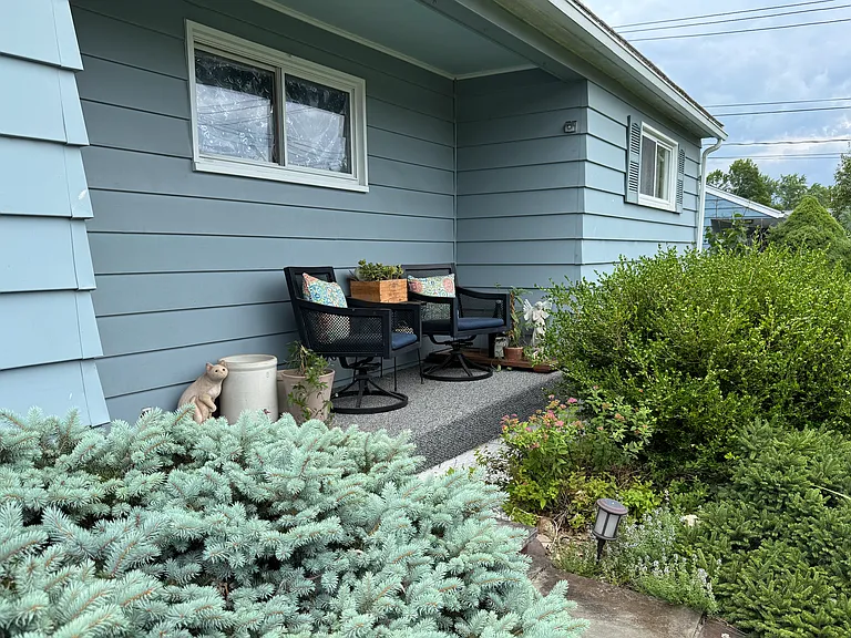 Front porch made private with evergreens