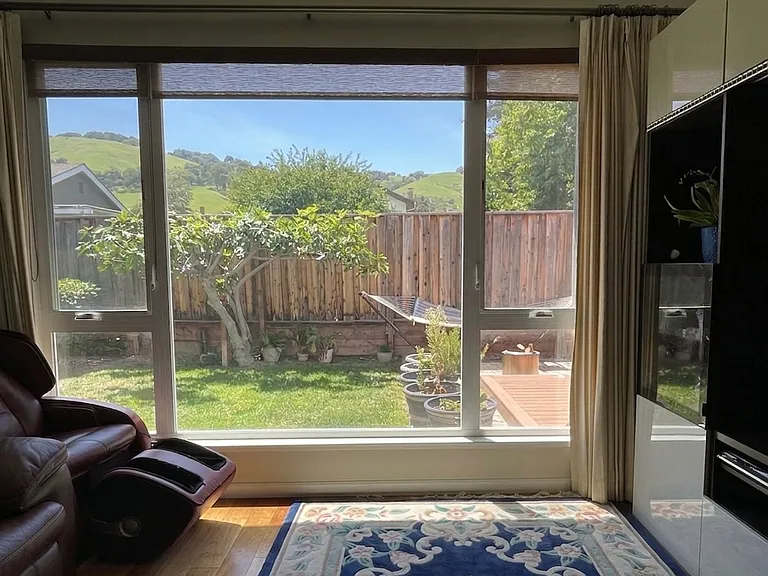 Living room with view of hillside.