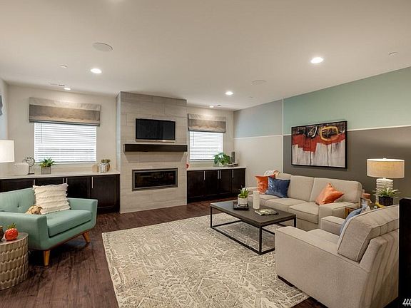 Great Room with contemporary gas fireplace and built-in cabinetry. Photo is from model home with the same floor plan and used for demonstration purposes only.
