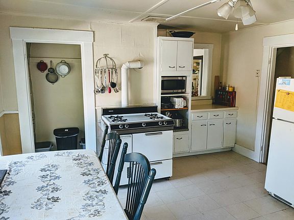 Large, bright eat-in kitchen with separate pantry storage.