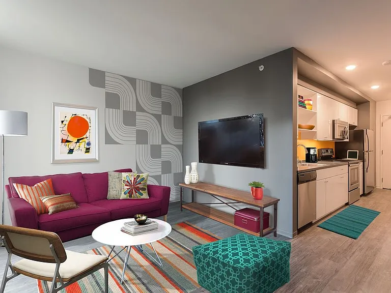 Open concept kitchen with stainless steel appliances and living area with hard surface flooring