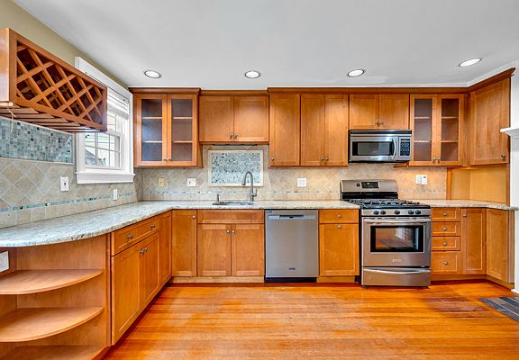 Kitchen with new dishwasher and microwave.
