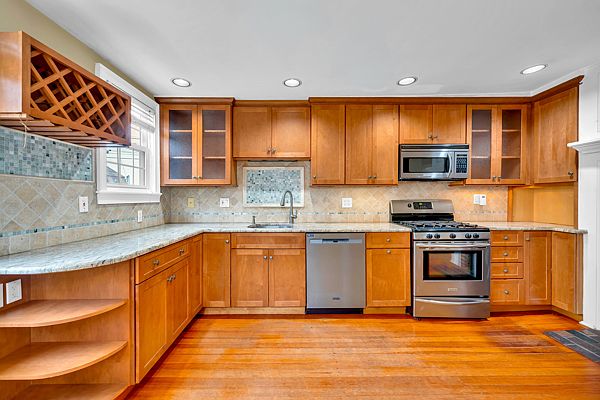 Kitchen with new dishwasher and microwave.