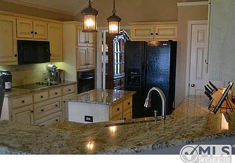 Wonderful kitchen with granites, center island, black appliance
