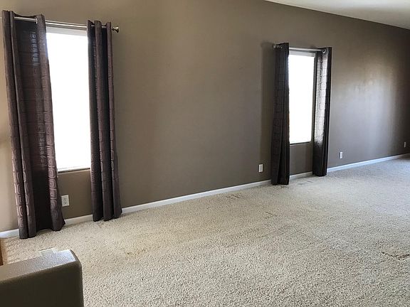 Living room with dining area to rear of photo.