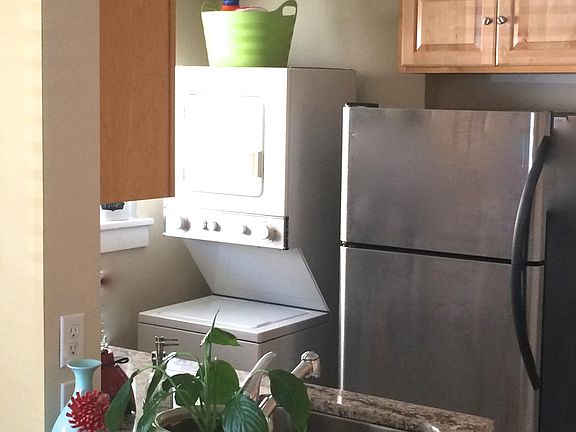 Notice the stainless appliances & clothes washer unit (good-