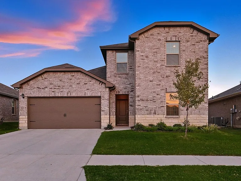 View of front of house featuring brick siding, a front yard, an attached garage, and concrete driveway