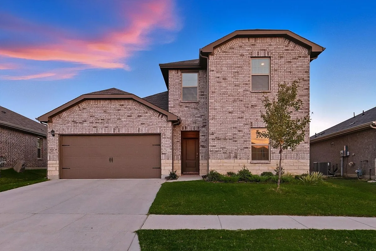 View of front of house featuring brick siding, a front yard, an attached garage, and concrete driveway - 1354 Turkey Run Dr