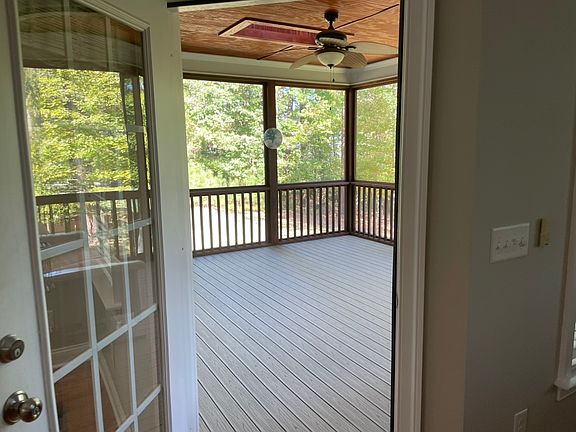 Exit Family Room to screened porch. Has ceiling and skylight