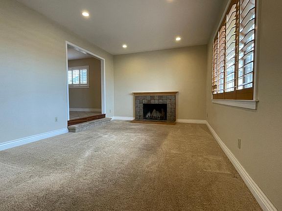 spacious and bright living room with recess lighting