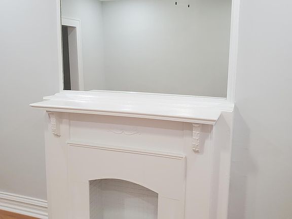 Decorative Fireplace in Front room with mirror