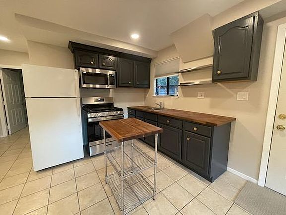 Kitchen with brand new stove and microwave.
