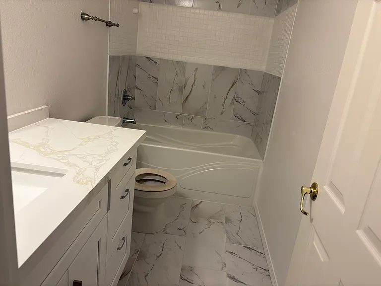 Full Bath in Master Bedroom No. 2 with Quartz Counter Tops, new ceramic floors.