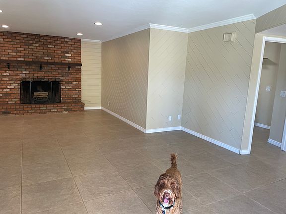 Family room with wood burning fireplace and French doors out to the patio/ pool area