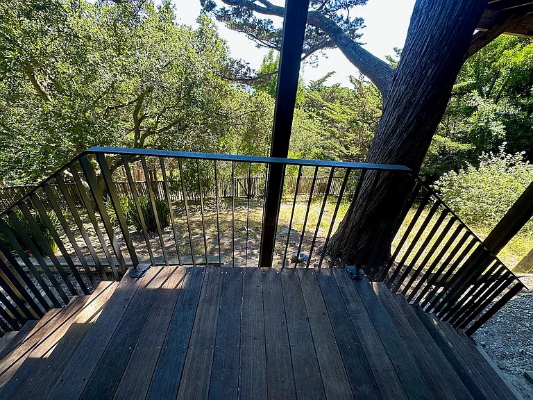 Lower exit from lower versatile bedroom. Steps exit to each side of the yard.