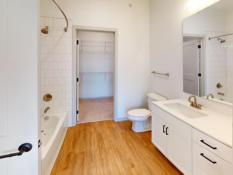 The Katherine floor plan's bathroom includes a washer and dryer, and leads into the walk-in closet for extra convenience. The Katherine floor plan's bathroom includes a washer and dryer, and leads into the walk-in closet for extra convenience.