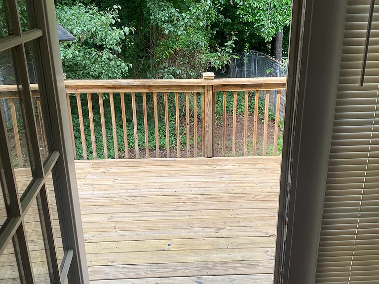 View of deck from back door in den.