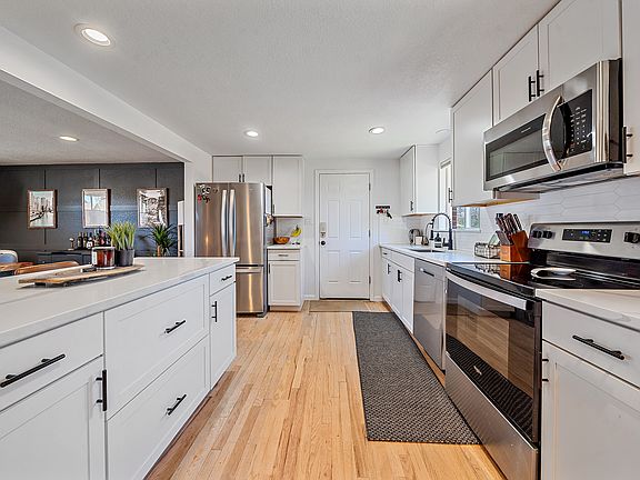 Modern kitchen outfitted with stainless steel appliances and all the essentials