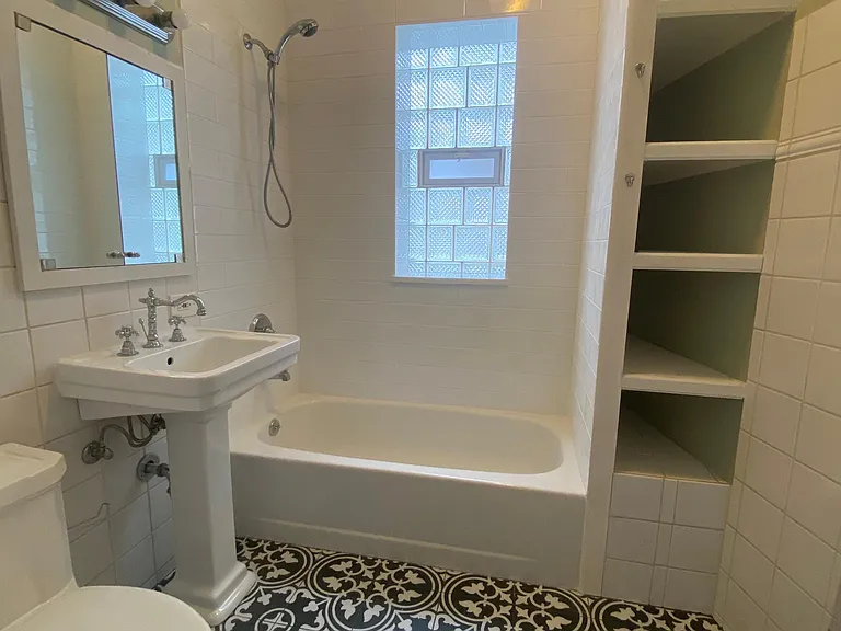 NEWLY TILED BATHROOM