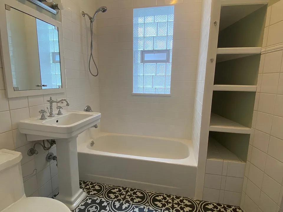 NEWLY TILED BATHROOM