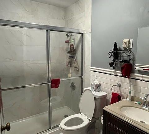 remodeled bathroom new granite, subway tile, toilet and vanity.