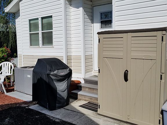 back of house with shed