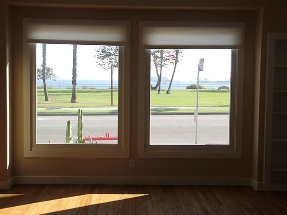 Living room view of the ocean through two large windows.