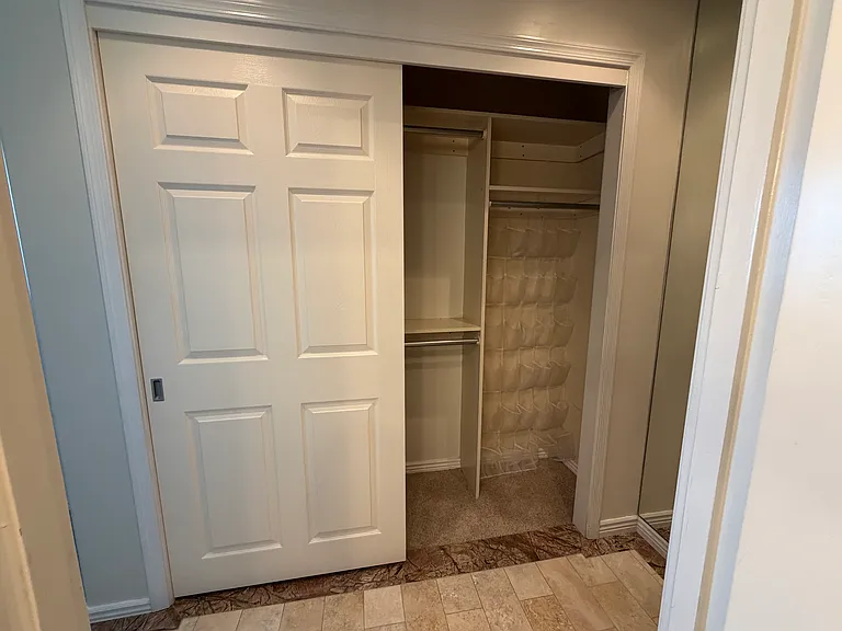Primary Closet - Storage, shelves, and rods built in.