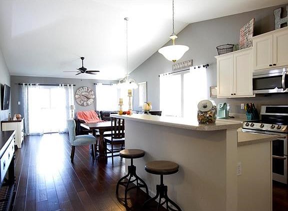 This house screams "open concept" with stainless steel appliances, vaulted ceilings, and amazing laminate wood flooring throughout the kitchen, dining room, and great room.