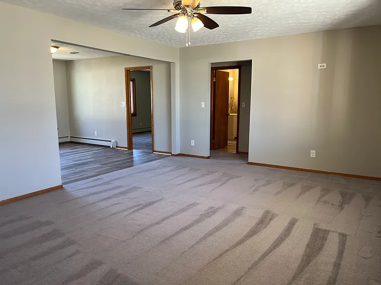 Living room with view to kitchen, one bedroom, and bathroom