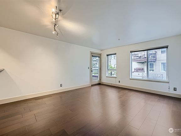 This 613 sq. ft. unit boasts gleaming hardwood floors. An access door off the living room area leads to a private balcony.>