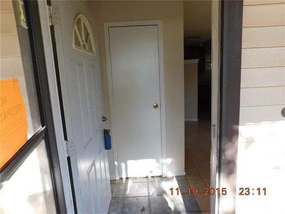 Foyer at front door with cloak closet