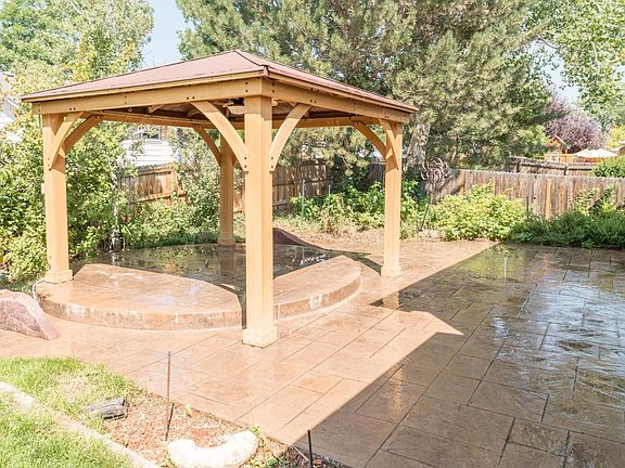Gazebo includes a ceiling fan with light and electrical outlets for stereo/string lights/outdoor movies, etc. Large raspberry patch next to fence.