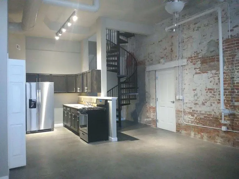 Main Level Kitchen and Entry with beautiful spiral staircase.