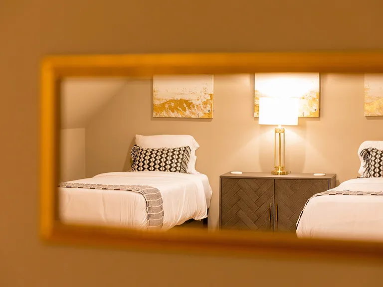 Workspace mirror reflection of 2 Twin beds. (Same room)