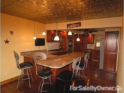 Kitchen
						:
						Custom cherry cabinets, granite counter tops, recessed and hanging lighting
