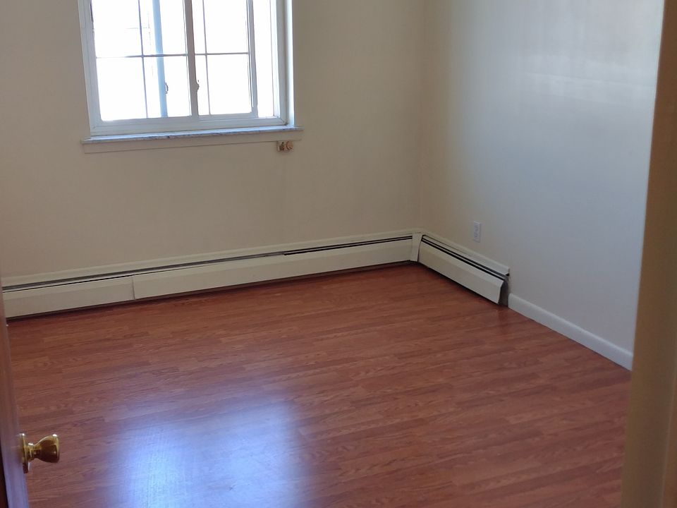 mid-sized bedroom with windows