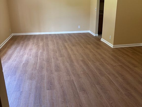 New LVP (luxury vinyl plank) in living/dining area with ceiling fan and freshly painted